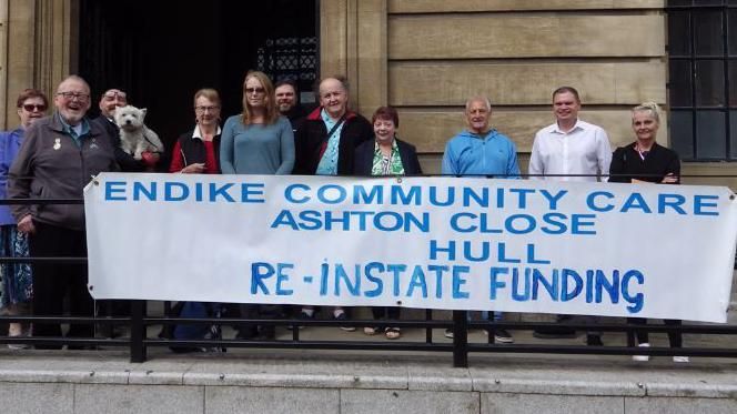 Supporters of Endike Community Care, with a banner, outside the Guildhall in Hull