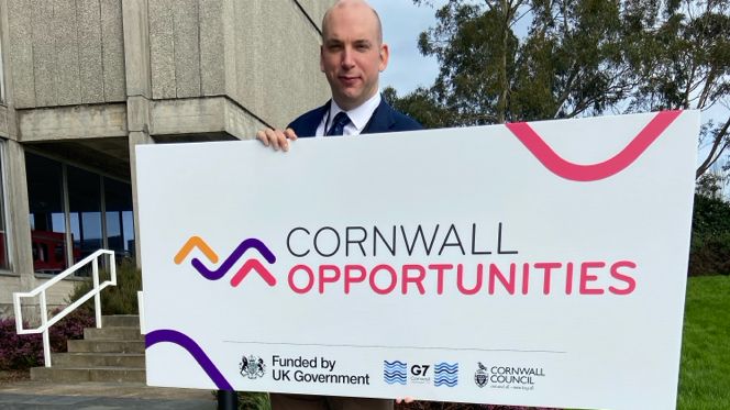 Cornwall Councillor Louis Gardner holding a sign launching the website 