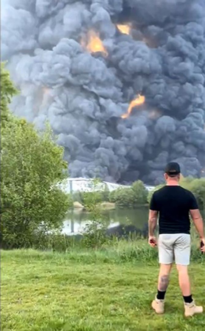 Smoke from the fire with a man in the foreground