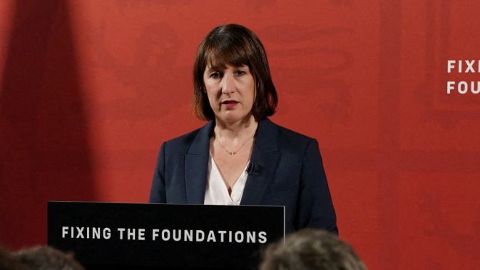 Chancellor of the Exchequer Rachel Reeves speaks during a press conference at a lectern with the slogan "fixing the foundations"