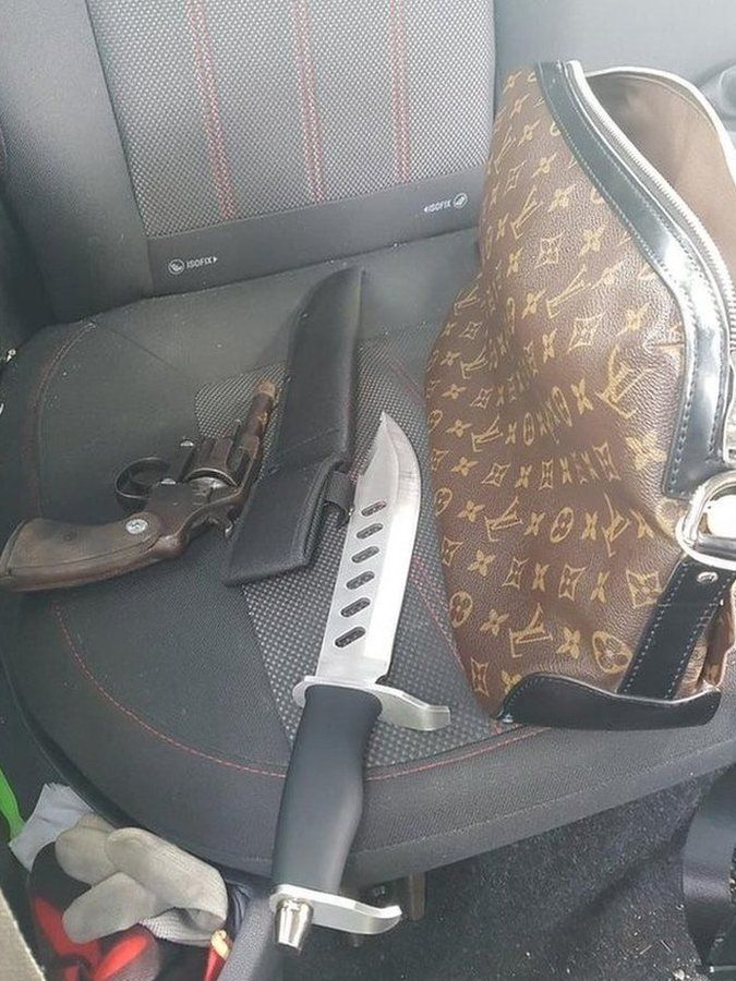 Designer handbag, a knife and a handgun on a car seat