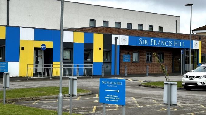 The front of Sir Francis Hill Community Primary School with a car park