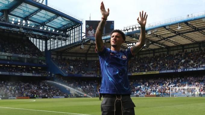 Jadon Sancho waves to the crowd at Stamford Bridge