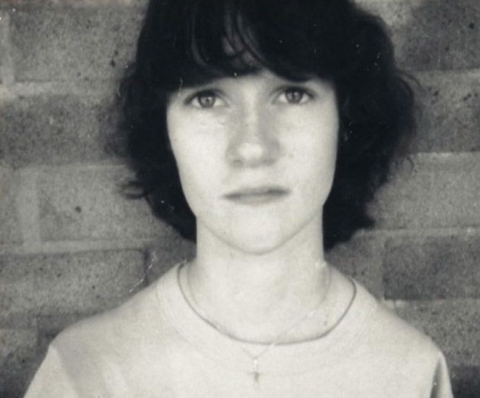 A black and white picture of Alison Lapper in her teens. She is staring directly at the camera and looks thoughtful. 