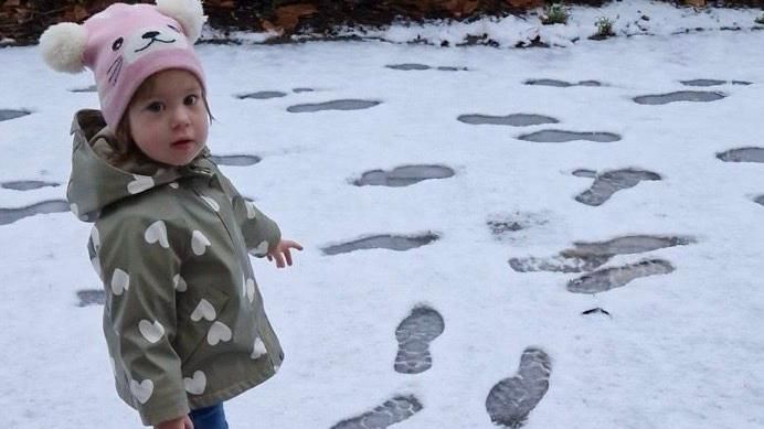 Young child walking in the snow 