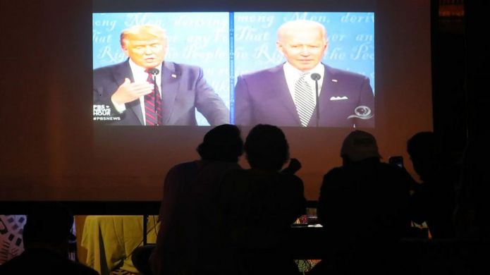 People in a Miami bar watch Donald Trump and Joe Biden participate in their first 2020 presidential campaign debate