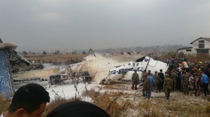 Photo of rescuers by the crashed plane