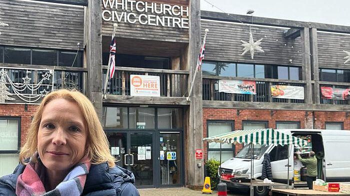 Helen Morgan stands outside Whitchurch Centre with a market stall in the background