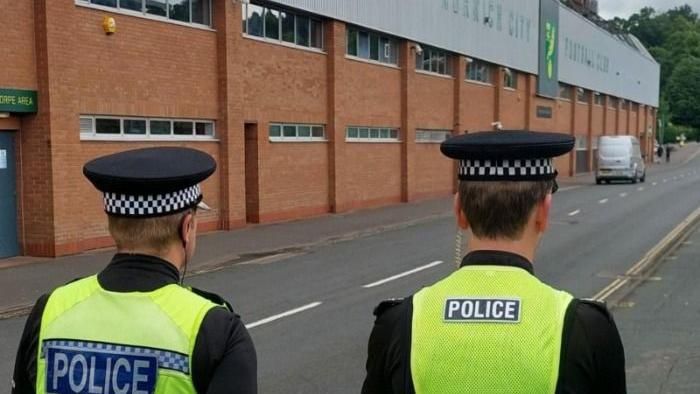 Police officers outside Carrow Road stadium
