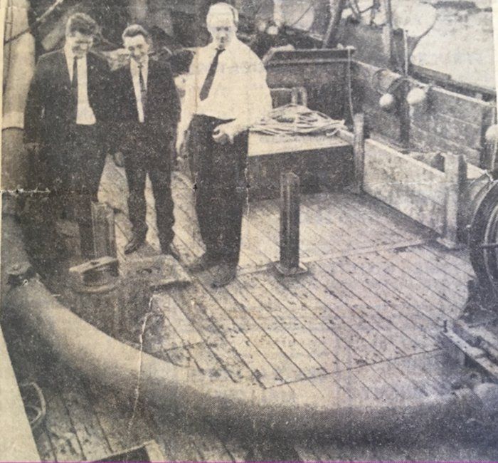 three men pictured with the davit