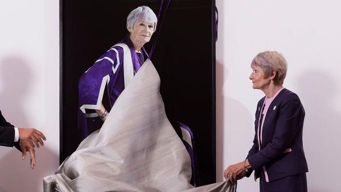 Dame Nancy Rothwell removes the cover of her portrait at an unveiling ceremony at the Whitworth in Manchester