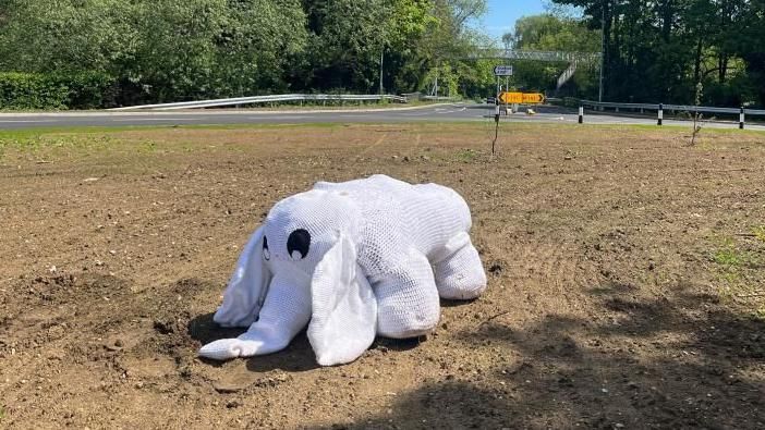 A stuffed white elephant on a roundabout 