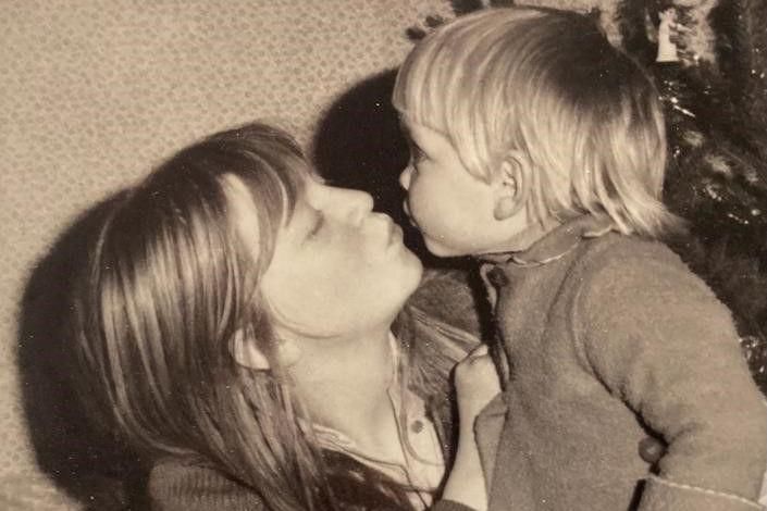 A black and white photo of Karen Constantine as a teenager with her baby son 