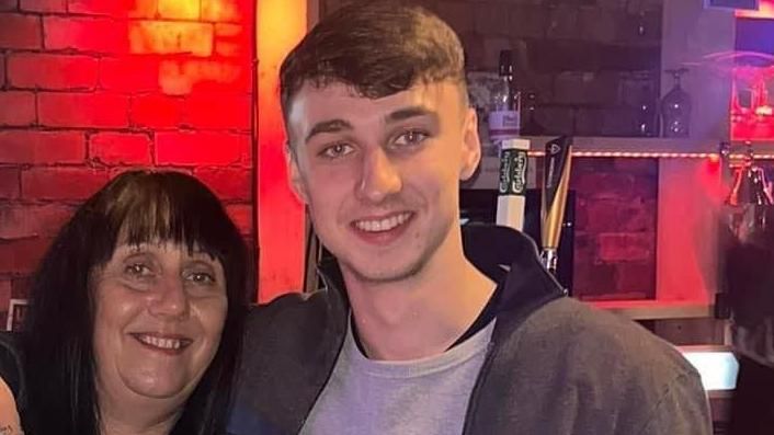 Jay Slater poses with his arm around his mother Debbie Duncan's shoulder. Both are smiling for the camera.