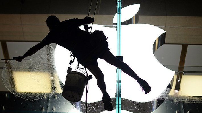 Man cleaning Apple logo