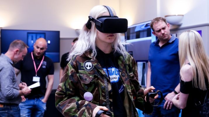 A conference attendee tries out an Oculus VR headset.