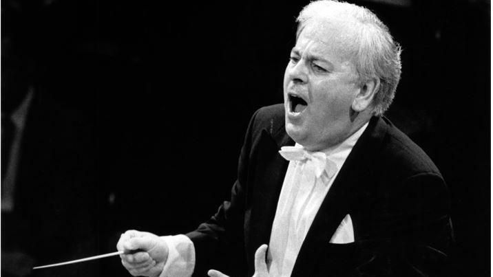 Black and white image of James Loughran conducting 