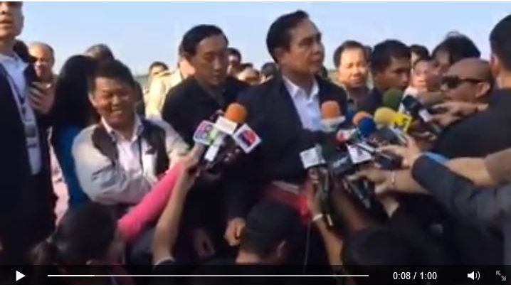 Prime Minister Prayuth pats a journalist's head