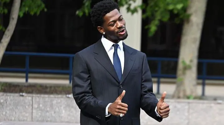 Lil Nas X being escorted by police after his arrest on Ventura Boulevard in Los Angeles
