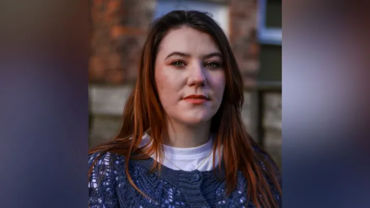 Jodie Morrow speaks to a news reporter outside a police station