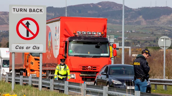 A line of slow‑moving vehicles forming a protest convoy on an Irish motorway