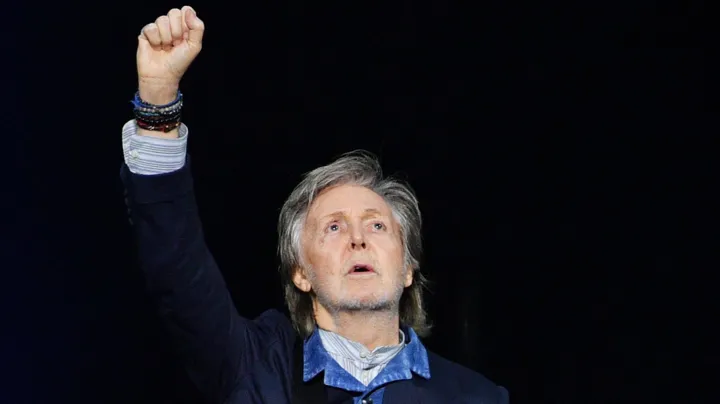 Getty Images Paul McCartney raises his hand to the air during a concert at the O2 Arena in December 2024