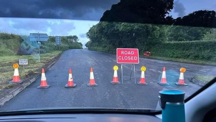 Traffic cones and 'road closed' sign