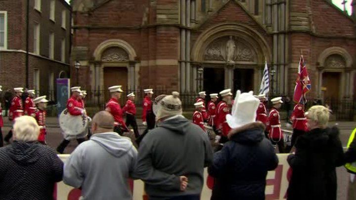 The feeder parade passed St Patrick's Church while residents looked on