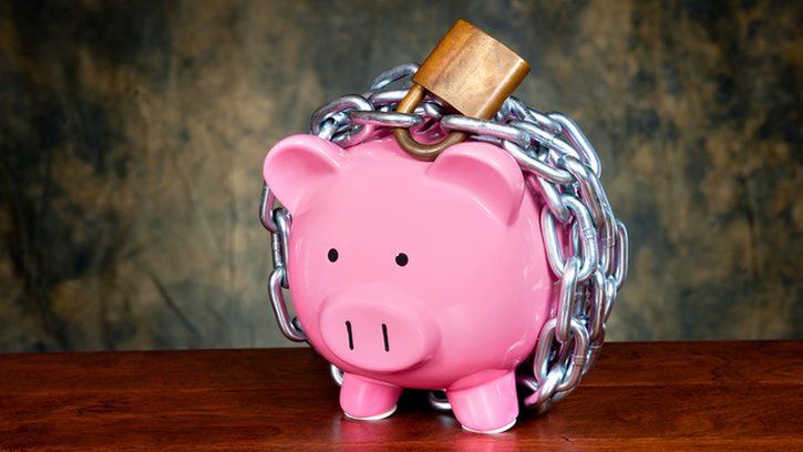 Piggy bank with lock and chain