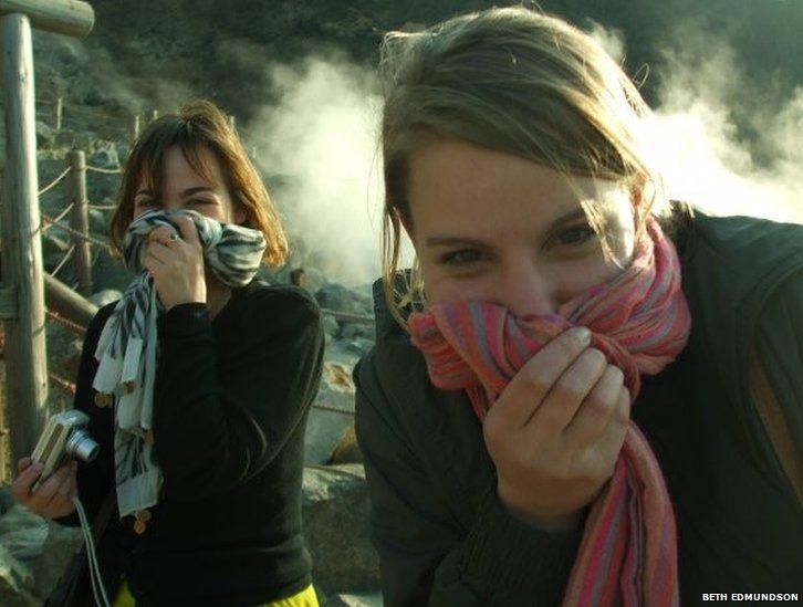 Two women covering their noses