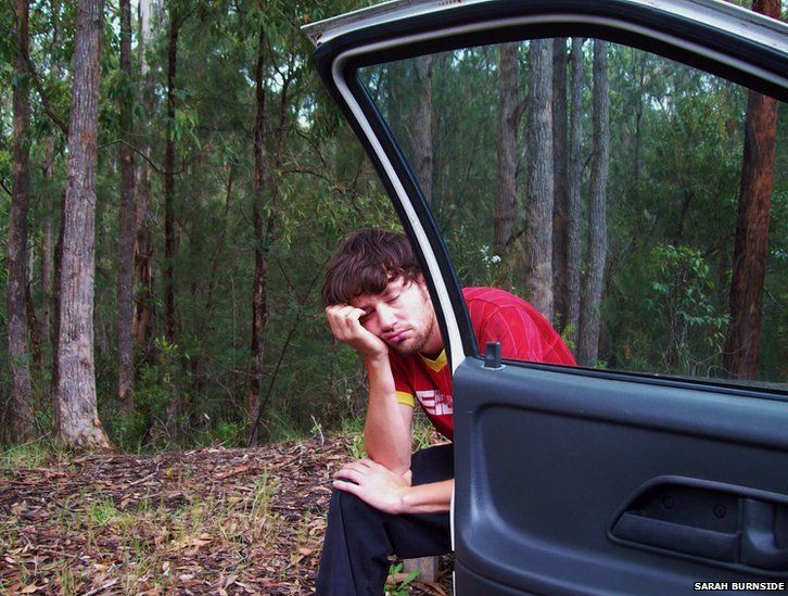 Man fed up beside car