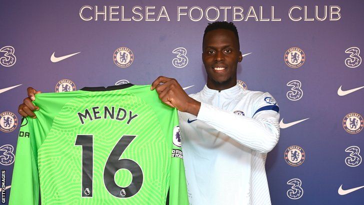 Senegal goalkeeper Edouard Mendy holding up his Chelsea shirt