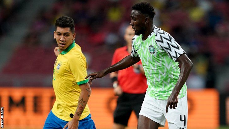 Leicester's Wilfred Ndidi (right) comes up against Liverpool's Roberto Firmino during an international friendly between Nigeria and Brazil