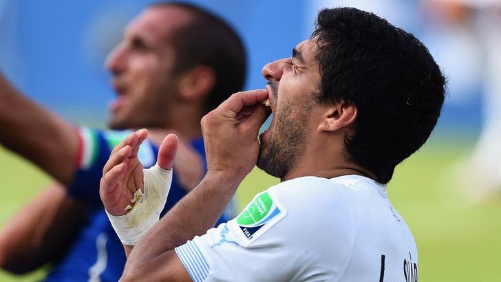 Luis Suarez after biting Italy's Giorgio Chiellini
