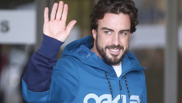 McLaren"s Formula One driver Alonso gestures to the media as he leaves a hospital where he has been hospitalized since Sunday, in Sant Cugat