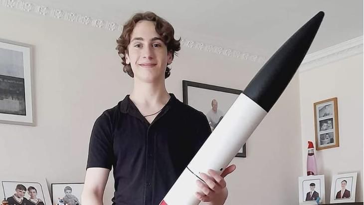 Charlie holding a white and black rocket