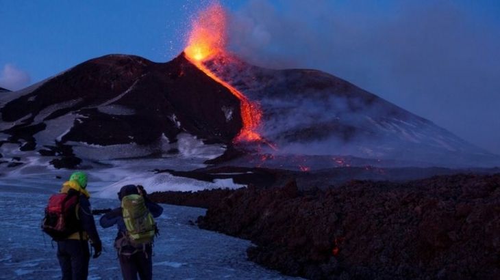 Volcano guides stand in front of Italy
