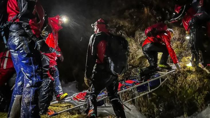 Mountain rescue volunteers carrying out a rescue at night
