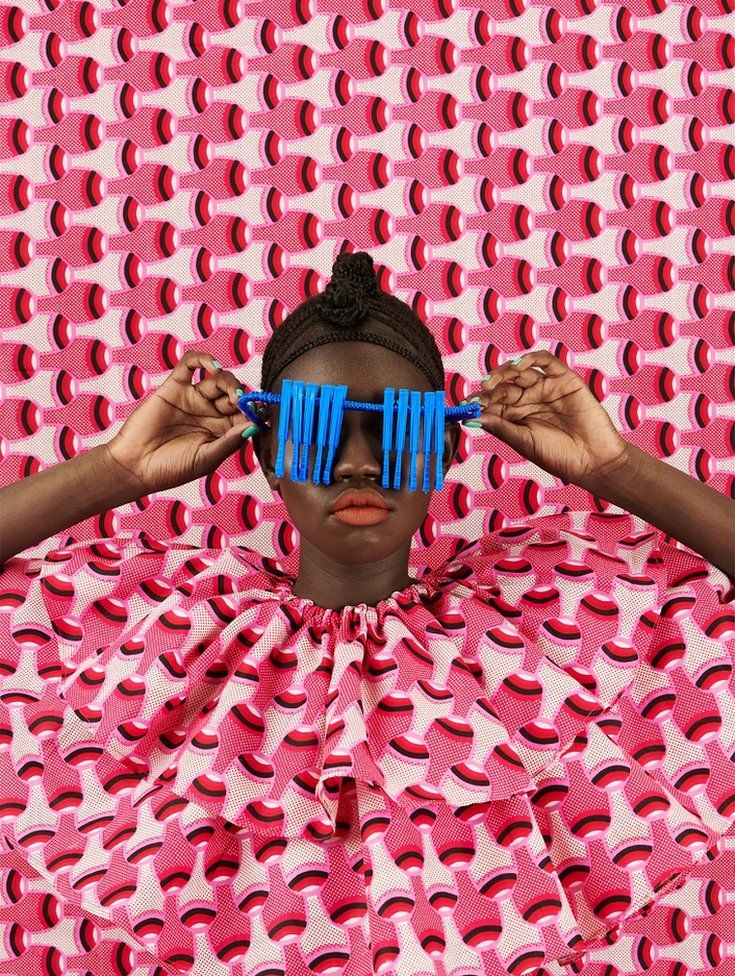 Woman disguised by colourful fabric