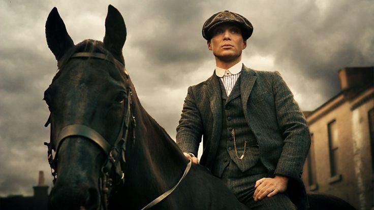 Cillian Murphy as Tommy Shelby, stood next to a horse