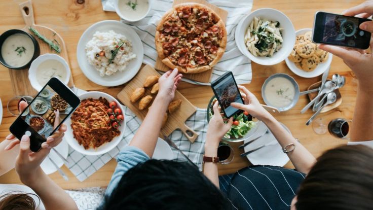 Gente sacándole foto a sus comidas