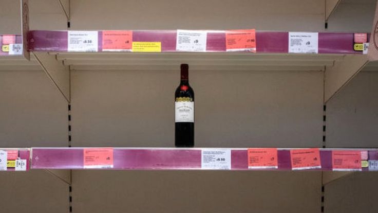 Bottle of wine on an empty supermarket shelf