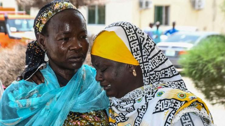 Two women consoling each other following the suicide bombing attacks in Gwoza