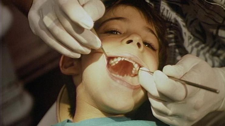 Boy having his teeth examined by a dentist