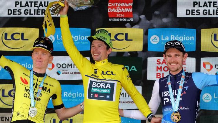 Matteo Jorgenson, Primoz Roglic and Derek Gee on the podium after finishing as the top three at the 2024 Criterium du Dauphine