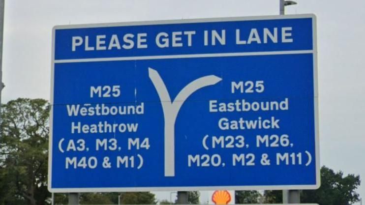 A road sign at a service station along the M25