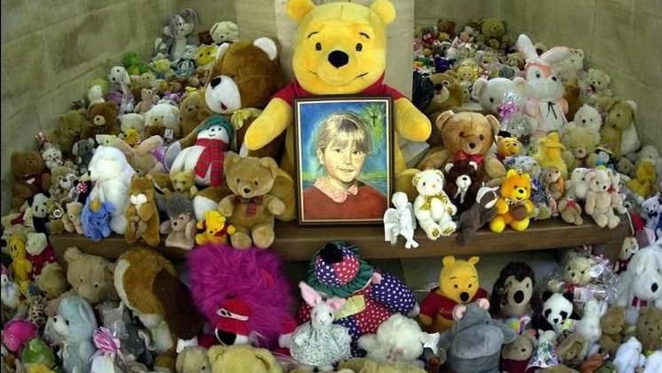 Toys placed around a framed picture