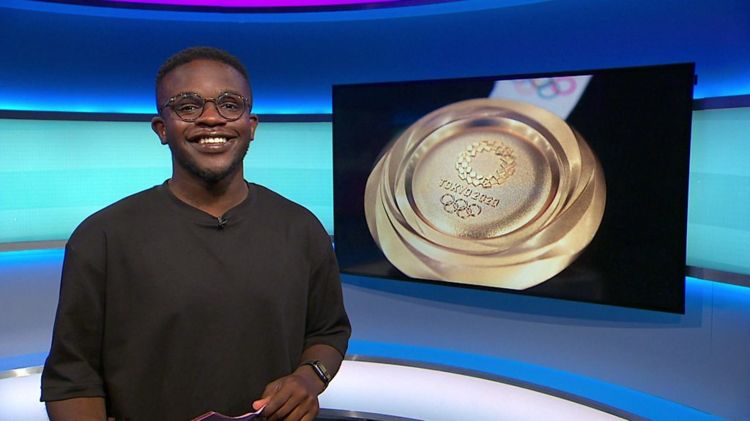 De-Graft on the Newsround set with a picture of a gold medal