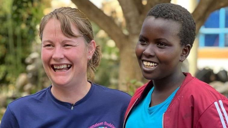 Gill Castle in Kenya standing next to one of the women her charity has helped 