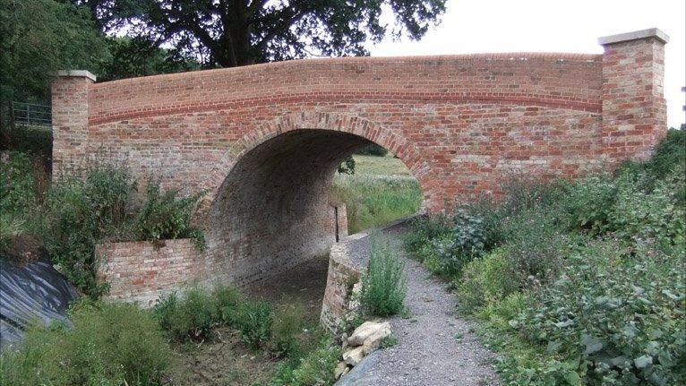 A bridge over a refurbished section of canal